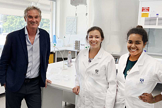 Three staff members in a lab